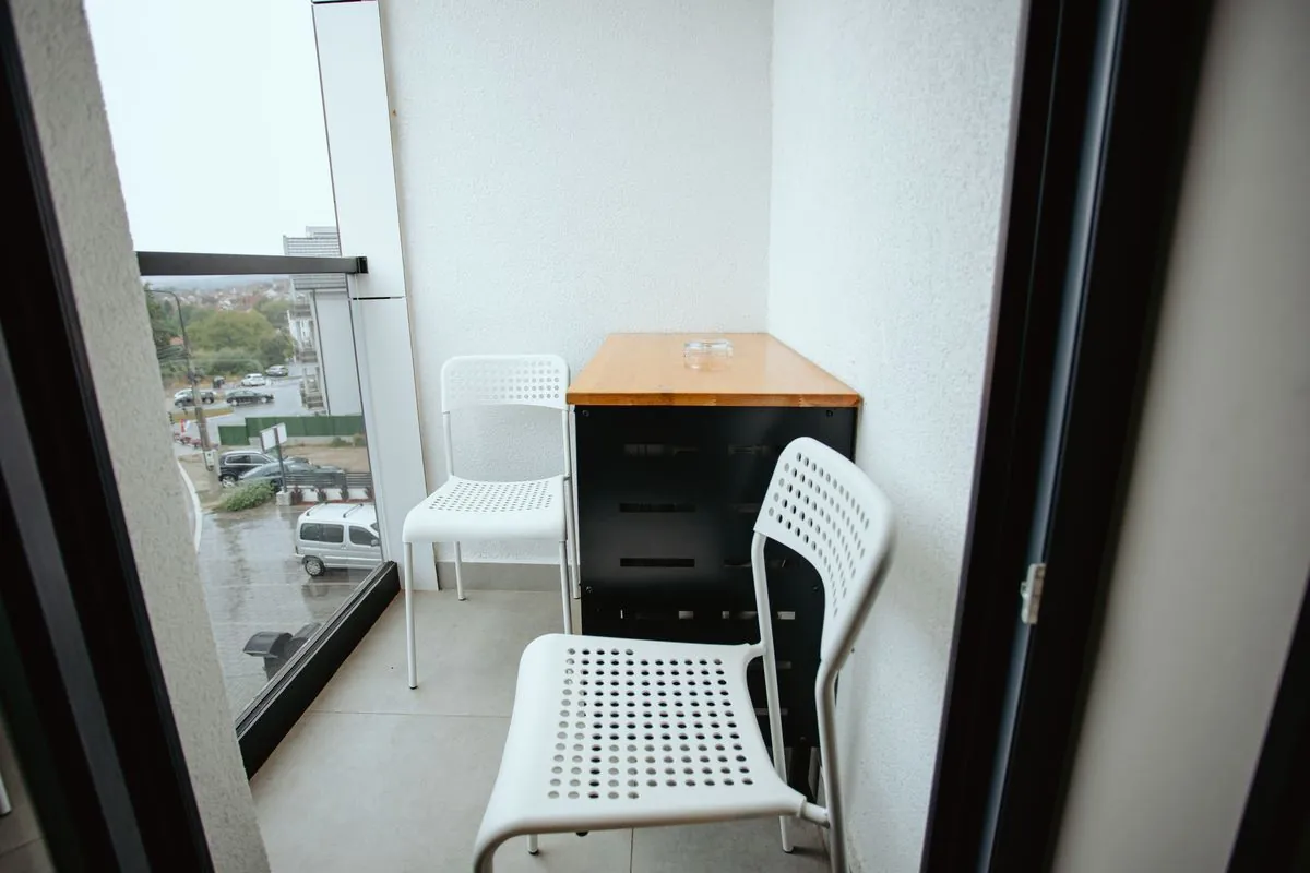 Balcony with a table and two chairs
