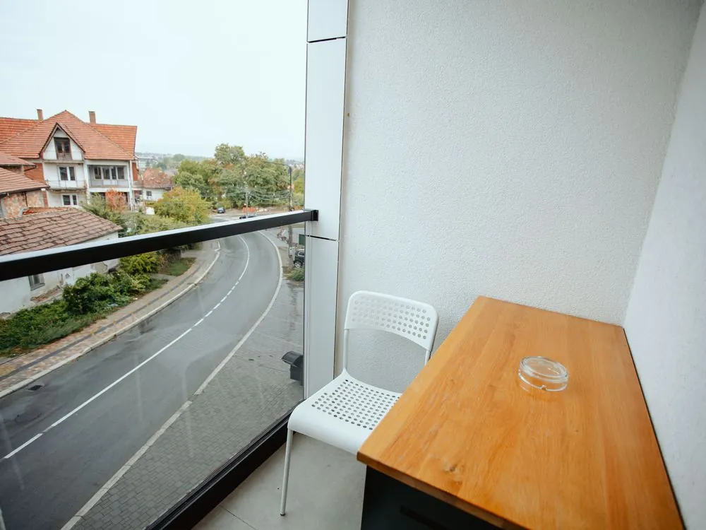 Studio balcony with a table and chair