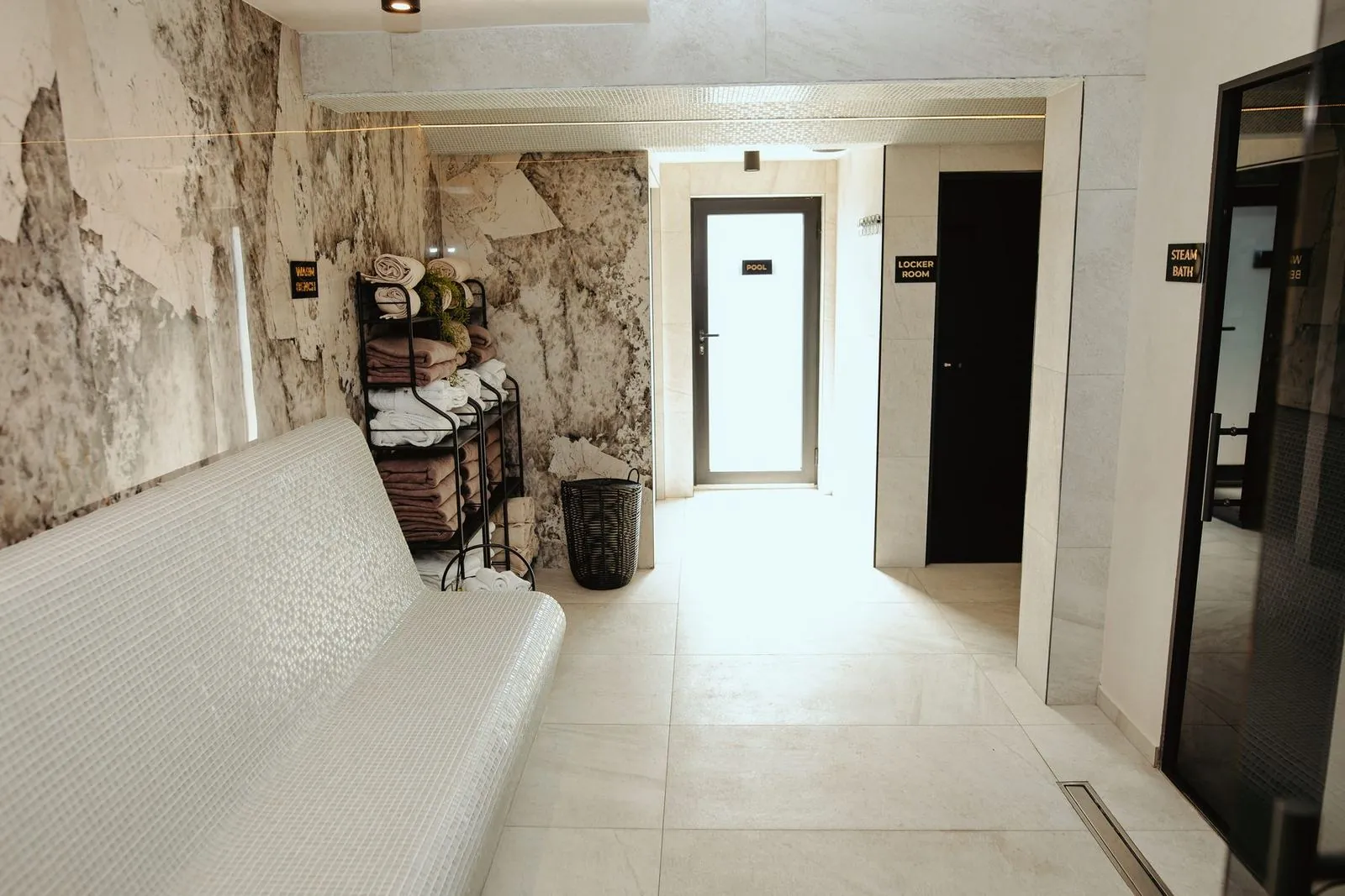 Spa corridor with a bench and a marble wall