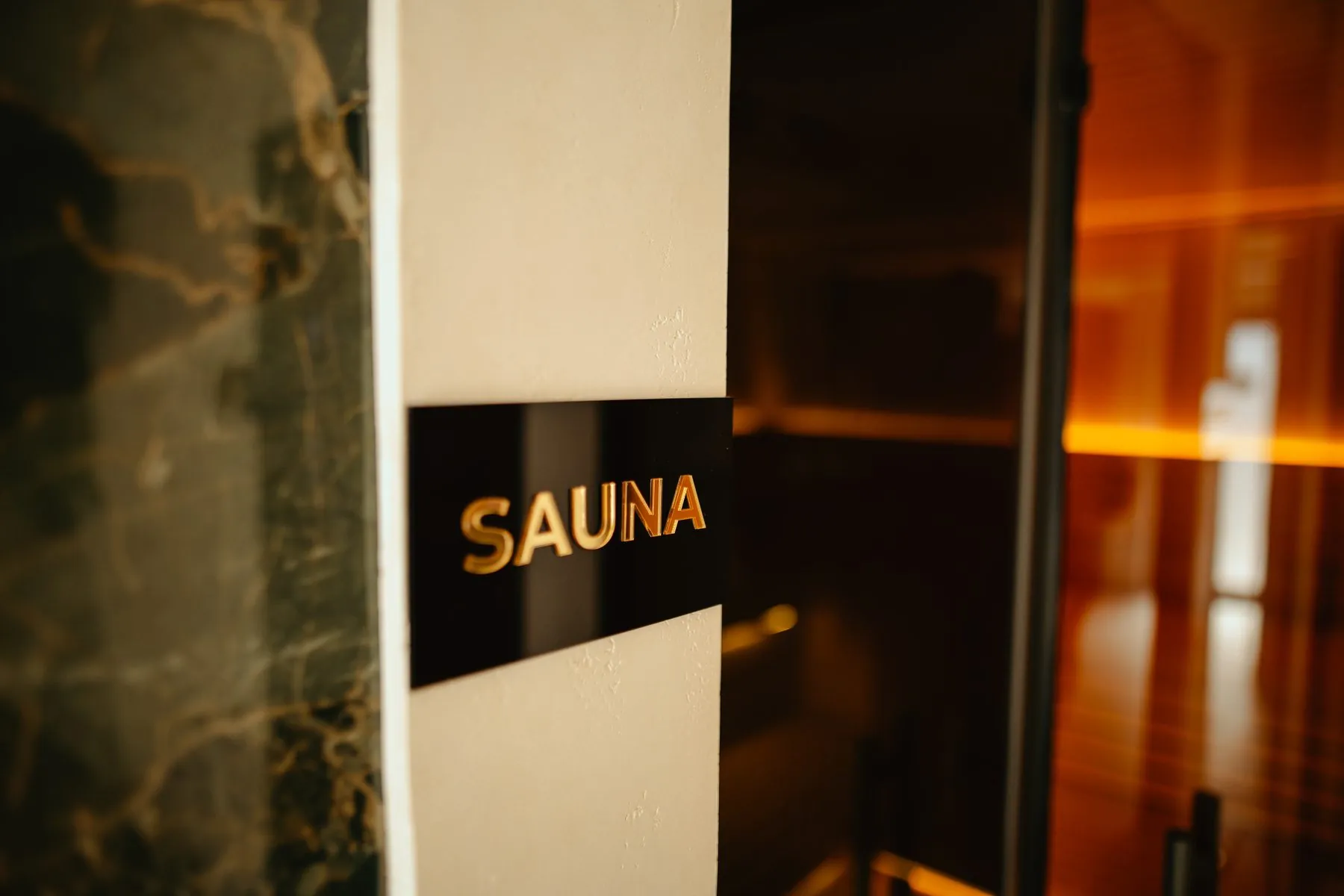 Sauna sign on a marble wall
