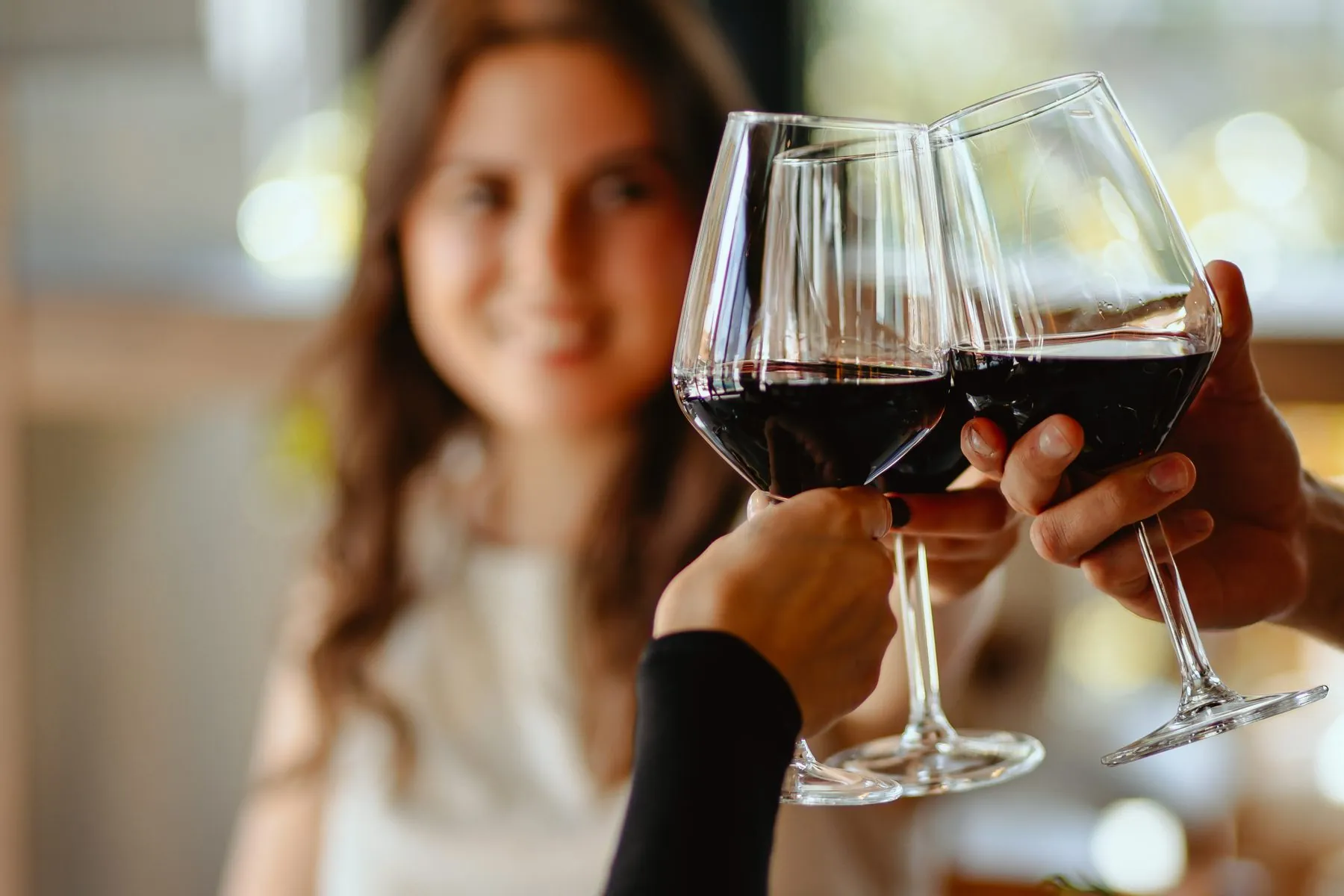 Glasses of red wine raised in a toast at the restaurant