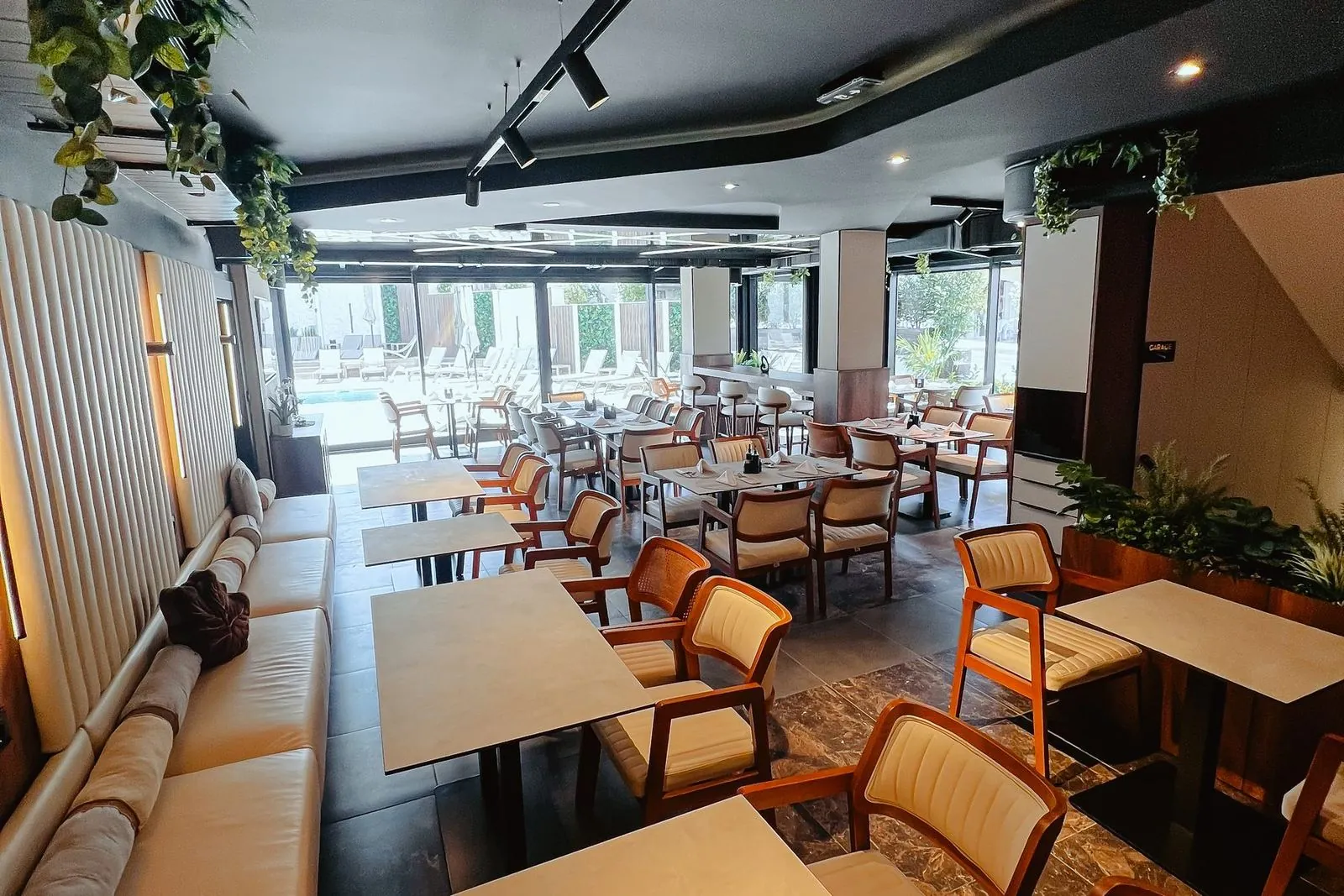 Lounge area of the dining room with a bench and tables